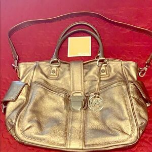 A Michael Kors Bronze handbag.